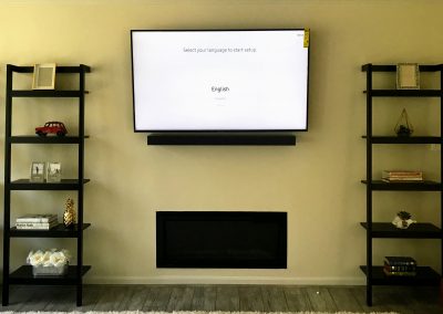 65' TV Wall Mounted with internal cord concealment and sound bar bracket below the TV