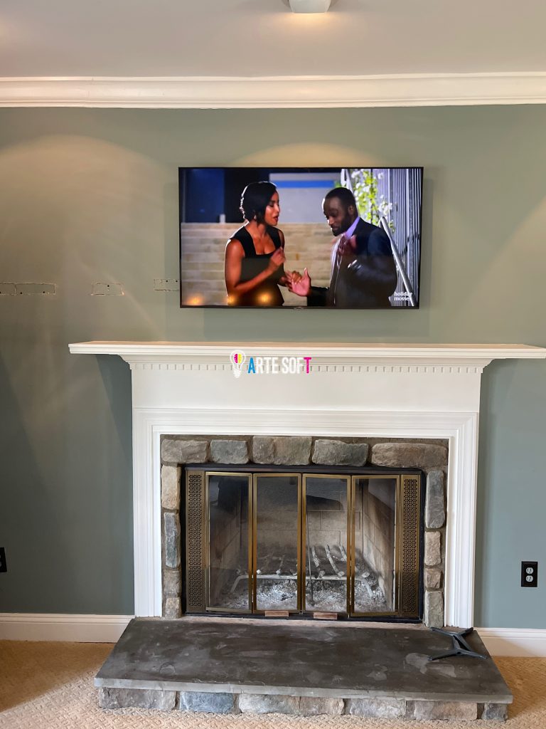 tv mounting above fireplace with cords hidden inside wall