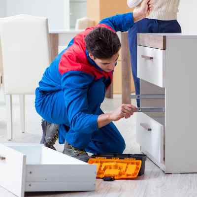 Handyman assembling furniture
